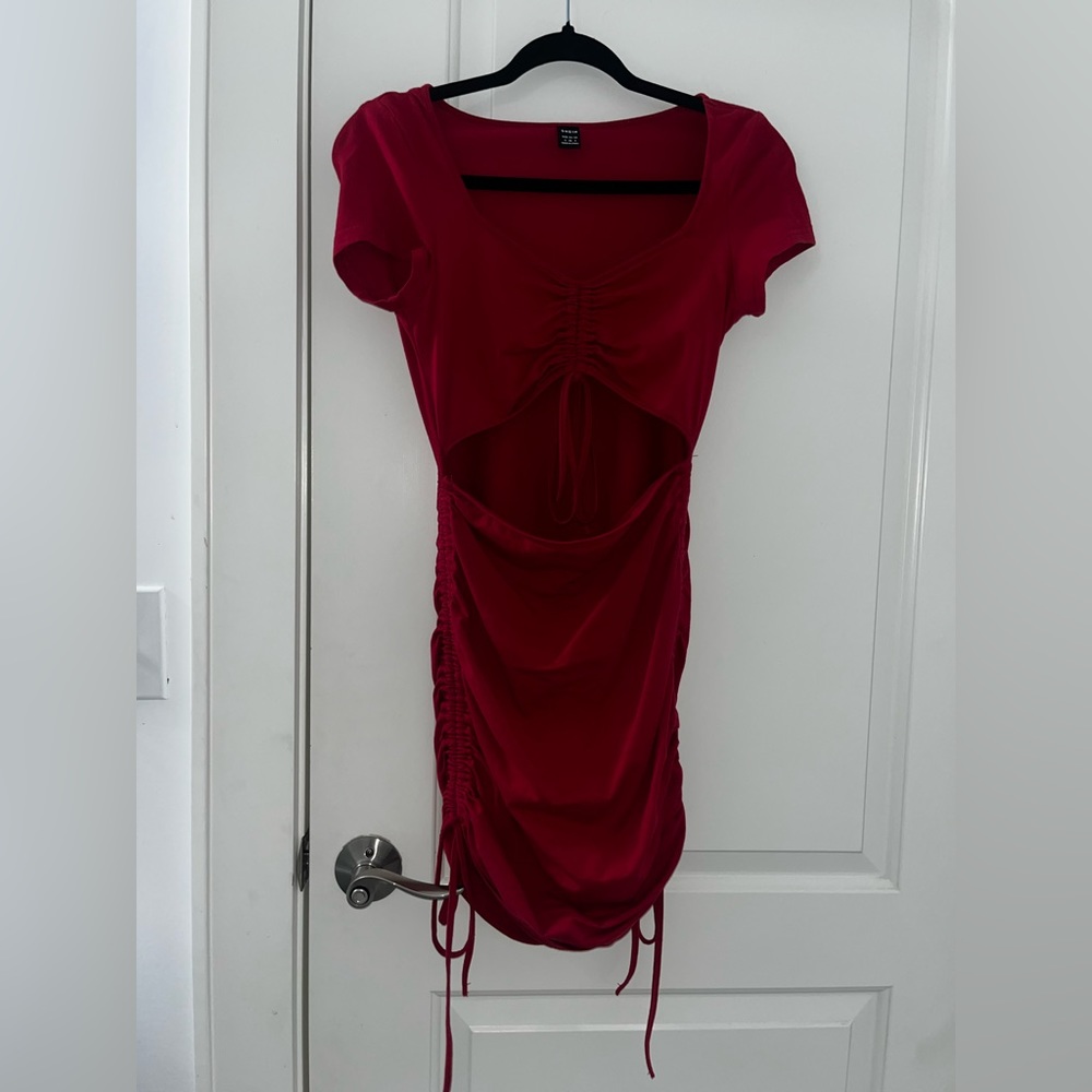 red dress with opening on upper abdomin area